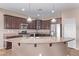 Modern kitchen features stainless appliances, granite counters, and eat-in island at 20934 N Sweet Dreams Dr, Maricopa, AZ 85138