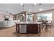 Island kitchen with stainless appliances, granite countertops open to dining and living areas at 20934 N Sweet Dreams Dr, Maricopa, AZ 85138