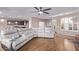 Open-concept living room features hardwood floors, with kitchen and entry views for easy living at 20934 N Sweet Dreams Dr, Maricopa, AZ 85138