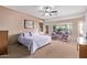 Spacious main bedroom with large windows, ceiling fan, and sitting area at 20934 N Sweet Dreams Dr, Maricopa, AZ 85138