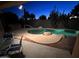 Backyard pool at twilight with desert landscaping, patio and view of the night sky at 20934 N Sweet Dreams Dr, Maricopa, AZ 85138