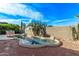 Private in-ground pool with rock features, mature cacti, and desert landscaping in backyard at 20934 N Sweet Dreams Dr, Maricopa, AZ 85138