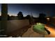 Nighttime view of a private pool with desert landscaping and soft lighting at 20934 N Sweet Dreams Dr, Maricopa, AZ 85138