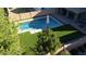 Aerial view of backyard oasis featuring a sparkling pool, lush turf, and outdoor living spaces at 21868 S 215Th St, Queen Creek, AZ 85142