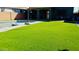 Lush backyard with artificial turf and a pool, ideal for outdoor entertainment and relaxation at 21868 S 215Th St, Queen Creek, AZ 85142