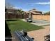Expansive backyard featuring artificial turf, a refreshing pool, and privacy fencing at 21868 S 215Th St, Queen Creek, AZ 85142