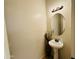 Elegant powder room features a pedestal sink, decorative vase and round mirror at 21868 S 215Th St, Queen Creek, AZ 85142