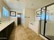Bright bathroom showcasing double sinks, a soaking tub, walk-in shower, and neutral tile flooring at 21868 S 215Th St, Queen Creek, AZ 85142