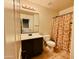 Bright bathroom with floral shower curtain, large mirror, and vanity at 21868 S 215Th St, Queen Creek, AZ 85142