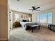 Spacious bedroom featuring plush carpet, a ceiling fan, and a king-size bed with stylish decor at 21868 S 215Th St, Queen Creek, AZ 85142