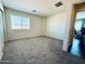Unfurnished bedroom with large window and neutral carpet flooring at 21868 S 215Th St, Queen Creek, AZ 85142