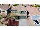 A birds eye view of a two-story home with an attached two car garage, small tree, and nicely landscaped yard at 21868 S 215Th St, Queen Creek, AZ 85142