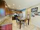 Spacious kitchen boasts stainless steel appliances, gorgeous counters, tile flooring, and a center island at 21868 S 215Th St, Queen Creek, AZ 85142