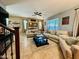 Spacious living room boasts tile flooring, ceiling fan and comfortable seating at 21868 S 215Th St, Queen Creek, AZ 85142