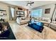 Bright living room with tile floors, ceiling fan and comfortable neutral furnishings at 21868 S 215Th St, Queen Creek, AZ 85142