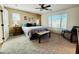 This main bedroom is complete with a ceiling fan, a large window, and ensuite bath at 21868 S 215Th St, Queen Creek, AZ 85142