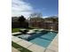 Sparkling backyard pool surrounded by artificial turf and desert landscaping, perfect for relaxation at 21868 S 215Th St, Queen Creek, AZ 85142