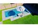 A private pool with turf and privacy wall creates a great space for outdoor fun at 21868 S 215Th St, Queen Creek, AZ 85142
