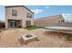 This home's backyard provides space to entertain with a fire pit and outdoor kitchen setup at 22714 N Chase Dr, Maricopa, AZ 85138