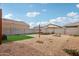 Well-maintained backyard with artificial turf, desert landscaping, trampoline, and fire pit for outdoor enjoyment at 22714 N Chase Dr, Maricopa, AZ 85138