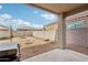 Outdoor living space with a covered patio, fire pit, and low-maintenance desert landscaping at 22714 N Chase Dr, Maricopa, AZ 85138