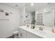 Bathroom featuring double sinks, a large mirror, and neutral fixtures at 22714 N Chase Dr, Maricopa, AZ 85138