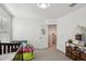 Bright bedroom with a crib, decorative wall stickers, and a view into the hall at 22714 N Chase Dr, Maricopa, AZ 85138