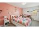 bedroom with fun decor, bedside table, and playful bedding for a cozy feel at 22714 N Chase Dr, Maricopa, AZ 85138