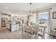 Open concept dining area next to the kitchen with view of the backyard at 22714 N Chase Dr, Maricopa, AZ 85138