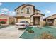 Charming two-story home features a desert landscape and a welcoming front porch at 22714 N Chase Dr, Maricopa, AZ 85138