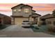 Charming two-story home featuring a two-car garage, stucco facade, and well-maintained landscaping at 22714 N Chase Dr, Maricopa, AZ 85138