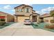 Charming two-story home featuring a two-car garage, stucco facade, and well-maintained landscaping at 22714 N Chase Dr, Maricopa, AZ 85138
