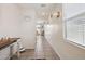 Well-lit hallway with tile flooring and neutral paint at 22714 N Chase Dr, Maricopa, AZ 85138