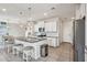 Bright kitchen with stainless steel appliances, granite countertops, white cabinets, and an adjacent dining area at 22714 N Chase Dr, Maricopa, AZ 85138
