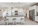 Open kitchen features granite countertops, stainless steel appliances, white cabinets, and bar stool seating at 22714 N Chase Dr, Maricopa, AZ 85138