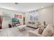 Bright living room with tile floors, neutral furniture, and large windows at 22714 N Chase Dr, Maricopa, AZ 85138