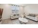 Bright living room with tile floors, neutral furniture, and large windows at 22714 N Chase Dr, Maricopa, AZ 85138