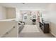 Upstairs loft with neutral carpet, a comfortable couch, vanity area, and large windows offering abundant natural light at 22714 N Chase Dr, Maricopa, AZ 85138