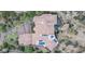Aerial view of an estate with a red tile roof, desert landscaping, pool, and solar panels at 25572 N 113Th Way, Scottsdale, AZ 85255