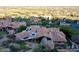Expansive property with a red tile roof and solar panels, nestled in a lush, green landscape at 25572 N 113Th Way, Scottsdale, AZ 85255
