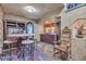 Cozy bar area with stone wall accents, built-in cabinets, and decorative lighting at 25572 N 113Th Way, Scottsdale, AZ 85255