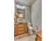 Elegant powder room features a stylish vanity with drawers, stone countertop, and unique mirror at 25572 N 113Th Way, Scottsdale, AZ 85255