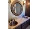 Bathroom with dual copper sinks, stone countertop and decorative mirror at 25572 N 113Th Way, Scottsdale, AZ 85255