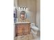 Well-lit bathroom with wooden vanity and tiled countertop at 25572 N 113Th Way, Scottsdale, AZ 85255