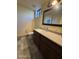 Neutral bathroom with stone floors, dark vanity, white counter and toilet at 25572 N 113Th Way, Scottsdale, AZ 85255