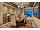 Dining room featuring a long, rustic wooden table, custom lighting, and a large window at 25572 N 113Th Way, Scottsdale, AZ 85255