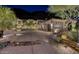 An opulent desert property featuring a textured driveway, stone accents, and a grand three-car garage at 25572 N 113Th Way, Scottsdale, AZ 85255