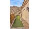 Exterior of property showing a landscaped path and door leading to a hillside desert rock formation at 25572 N 113Th Way, Scottsdale, AZ 85255