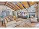 Living room with comfortable seating, stone fireplace, and expansive windows highlighting the architectural features at 25572 N 113Th Way, Scottsdale, AZ 85255