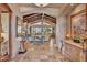 Inviting living room with stone fireplace, wood beam ceiling, and scenic backyard view at 25572 N 113Th Way, Scottsdale, AZ 85255